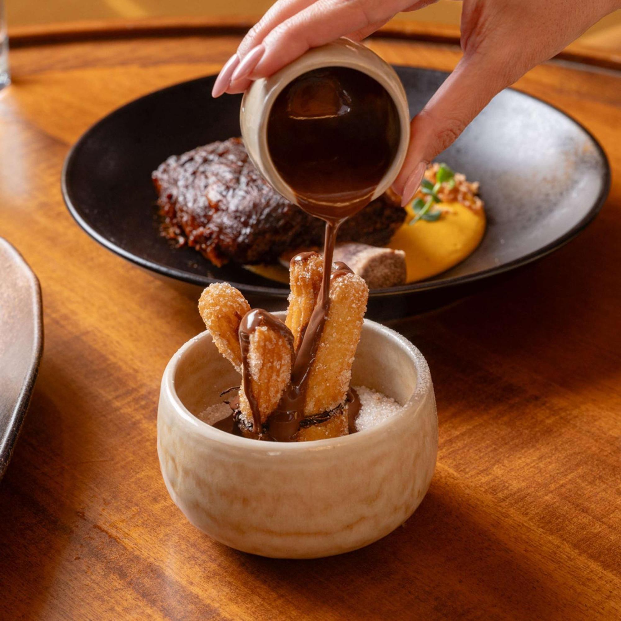 V Hotel Dubai, Curio Collection By Hilton المظهر الخارجي الصورة Soy sauce being poured on tempura